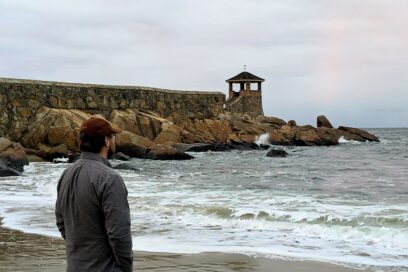 Image of the author at Rockport harbor, looking out at the sea in a wistful, cold atmosphere.