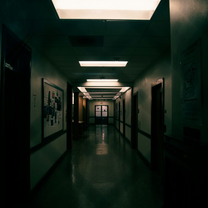 Bright surgical lights over a sterile operating theatre.