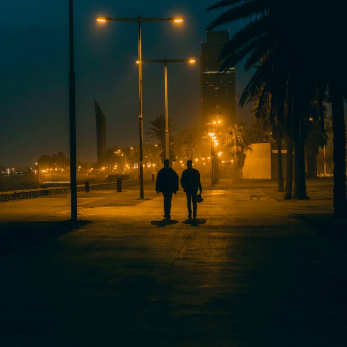 Warm string lights over an evening reception, guests blurred in the background.