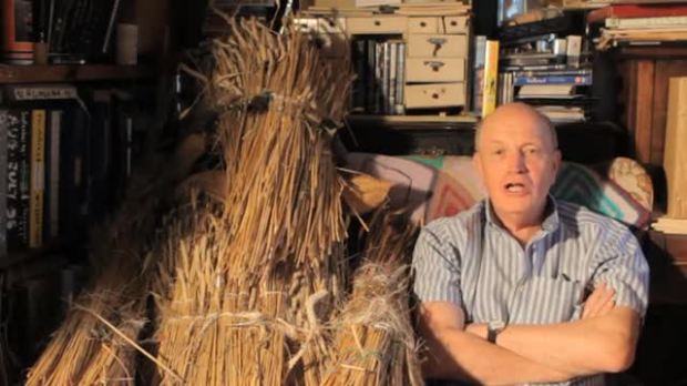 Iain Sinclair poses alongside a straw bear, one of the essential motifs of By Our Selves.