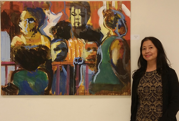 Gloria Pacis beside her painting, Jersey City. Photographed at the Monroe Arts Center