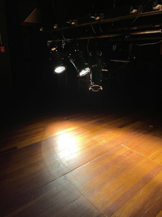 Spotlight on a stage, symbolising discovery of new literary voices.