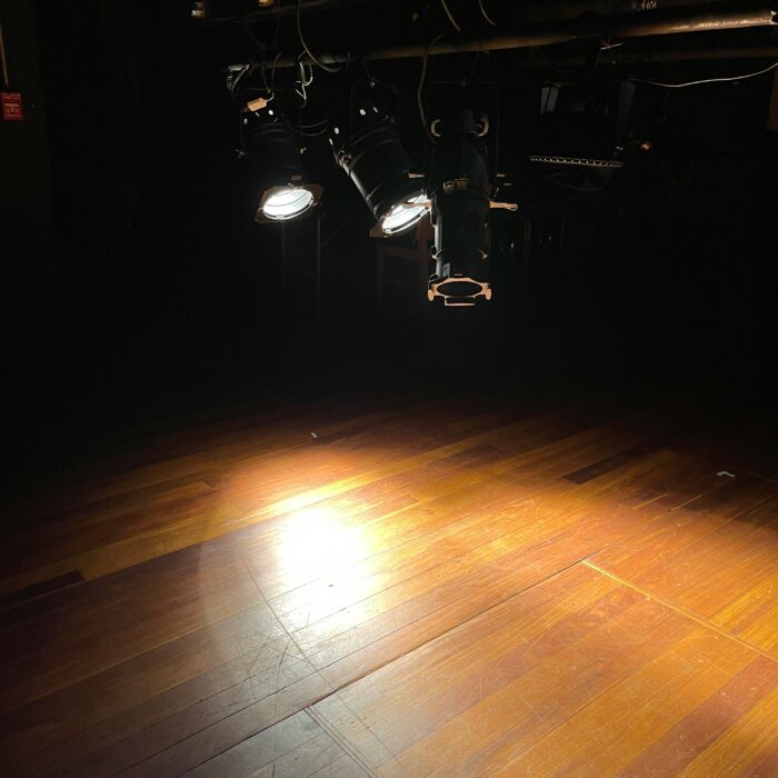 Spotlight on a stage, symbolising discovery of new literary voices.