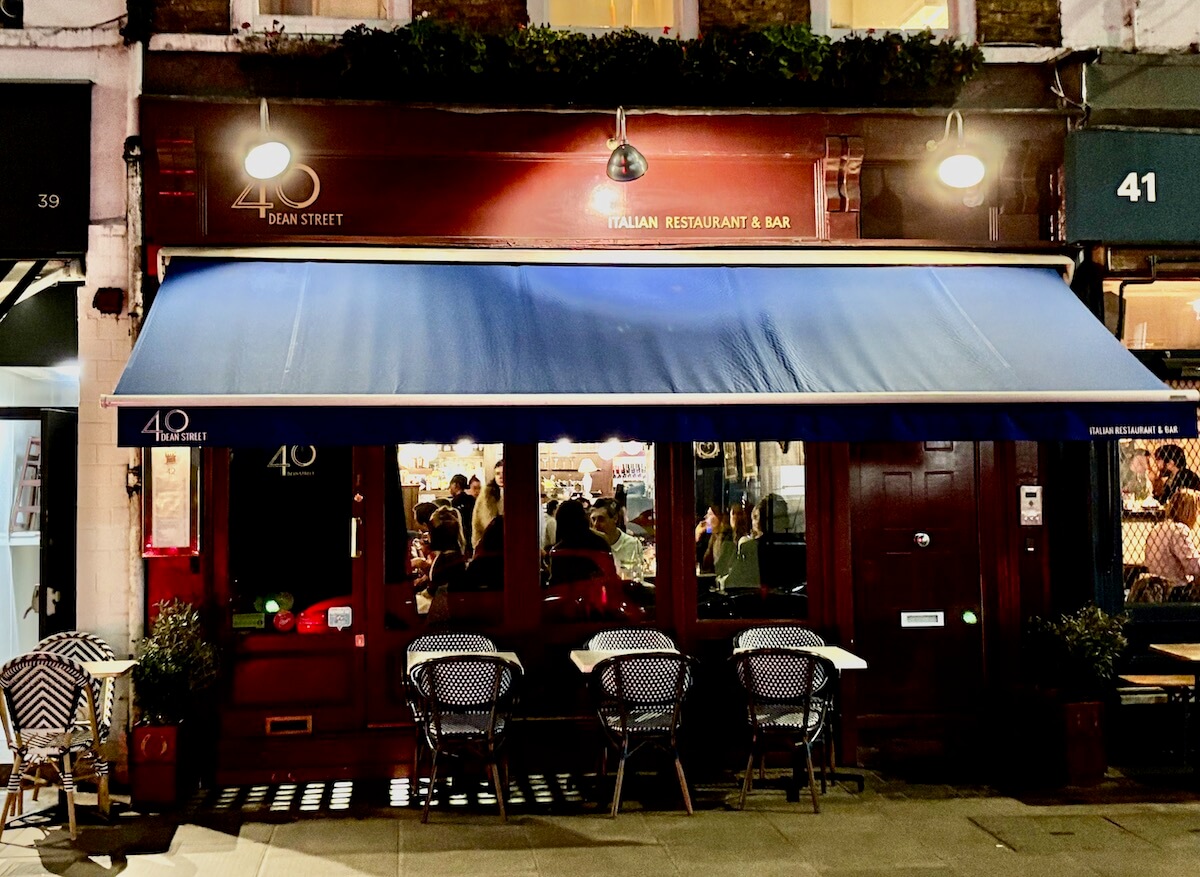 Exterior of 40 Dean Street restaurant in Soho at night.
