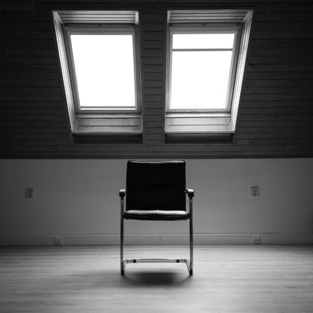 An empty chair in a quiet, naturally lit room.