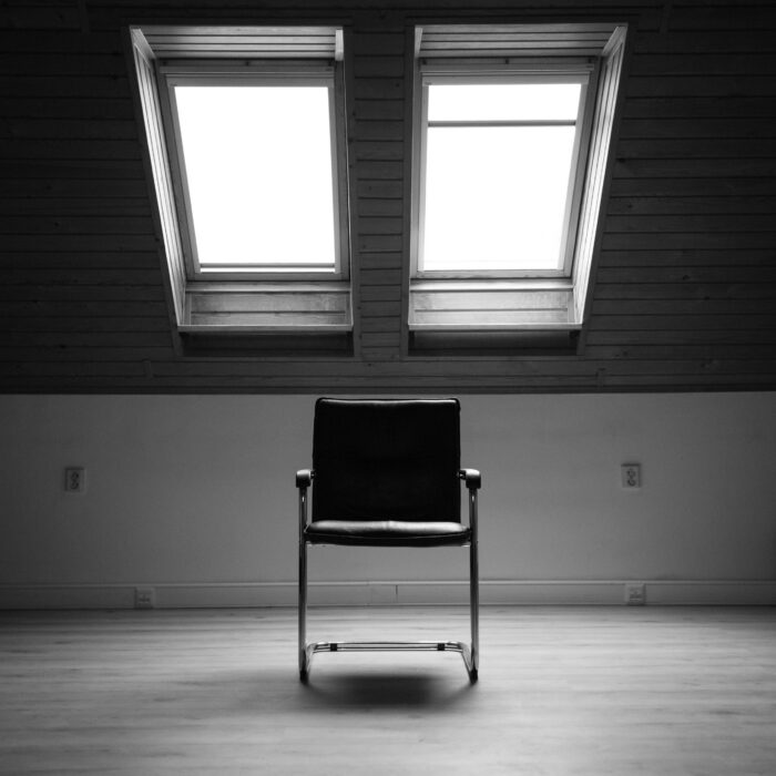 An empty chair in a quiet, naturally lit room.